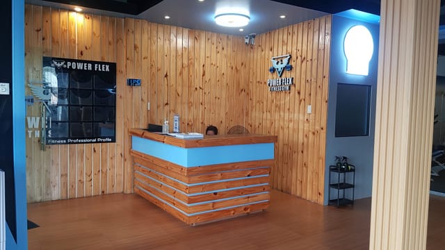 South Signal branch reception: pine-plank walls, a wooden front desk and an illuminated Power Flex eagle logo
